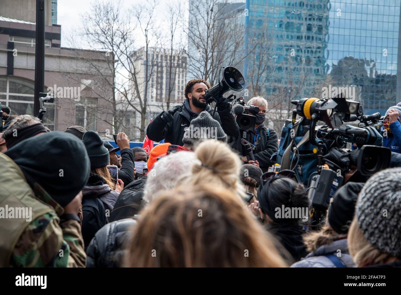 Minneapolis, Minnesota.   A crowd gathers in front of the government center courthouse listening to a speaker while waiting to hear the verdict to be Stock Photo