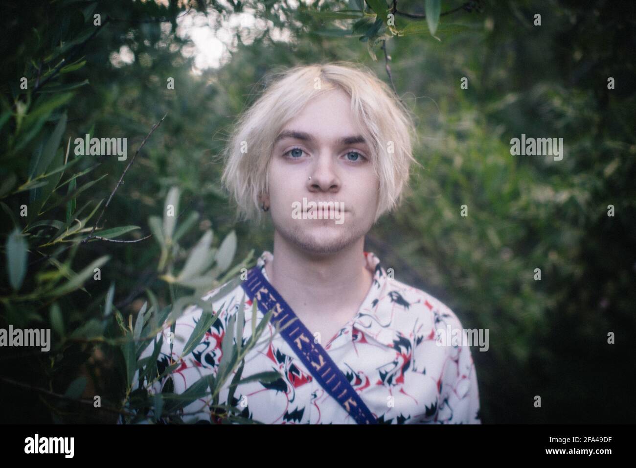 Soft Portrait of Blue Eyed Teen Boy in the Woods Stock Photo