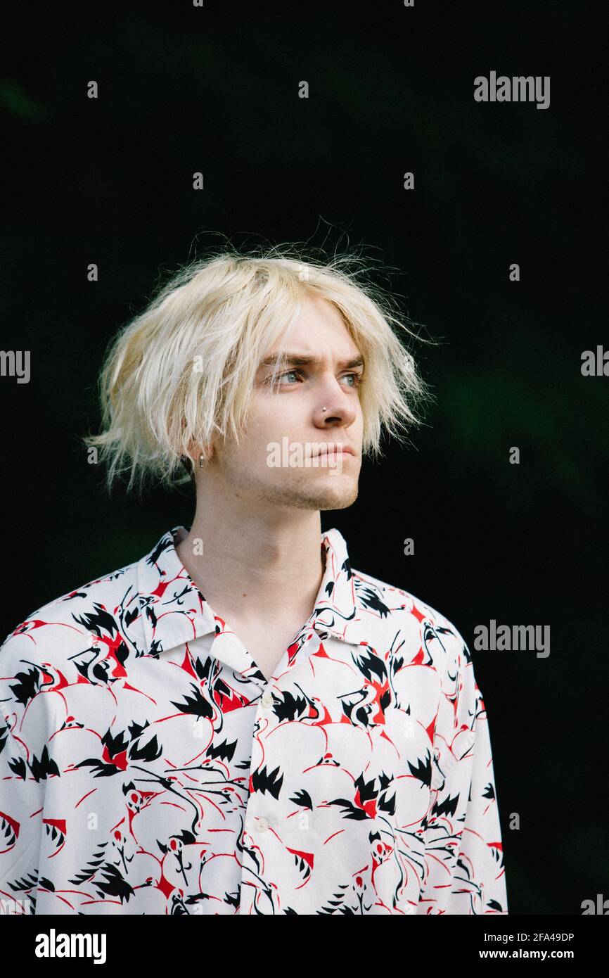 Cool Portrait of Teen Boy With Bleach Blonde Hair and Piercing Stock Photo
