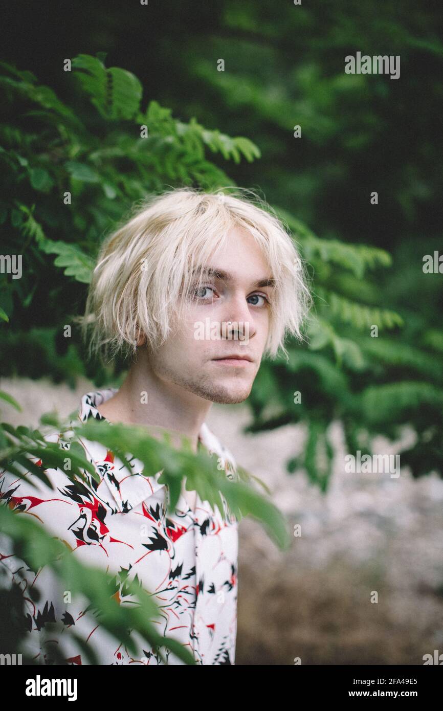 Portrait of Teen Boy With Bleach Blonde Hair and Blue Eyes Stock Photo
