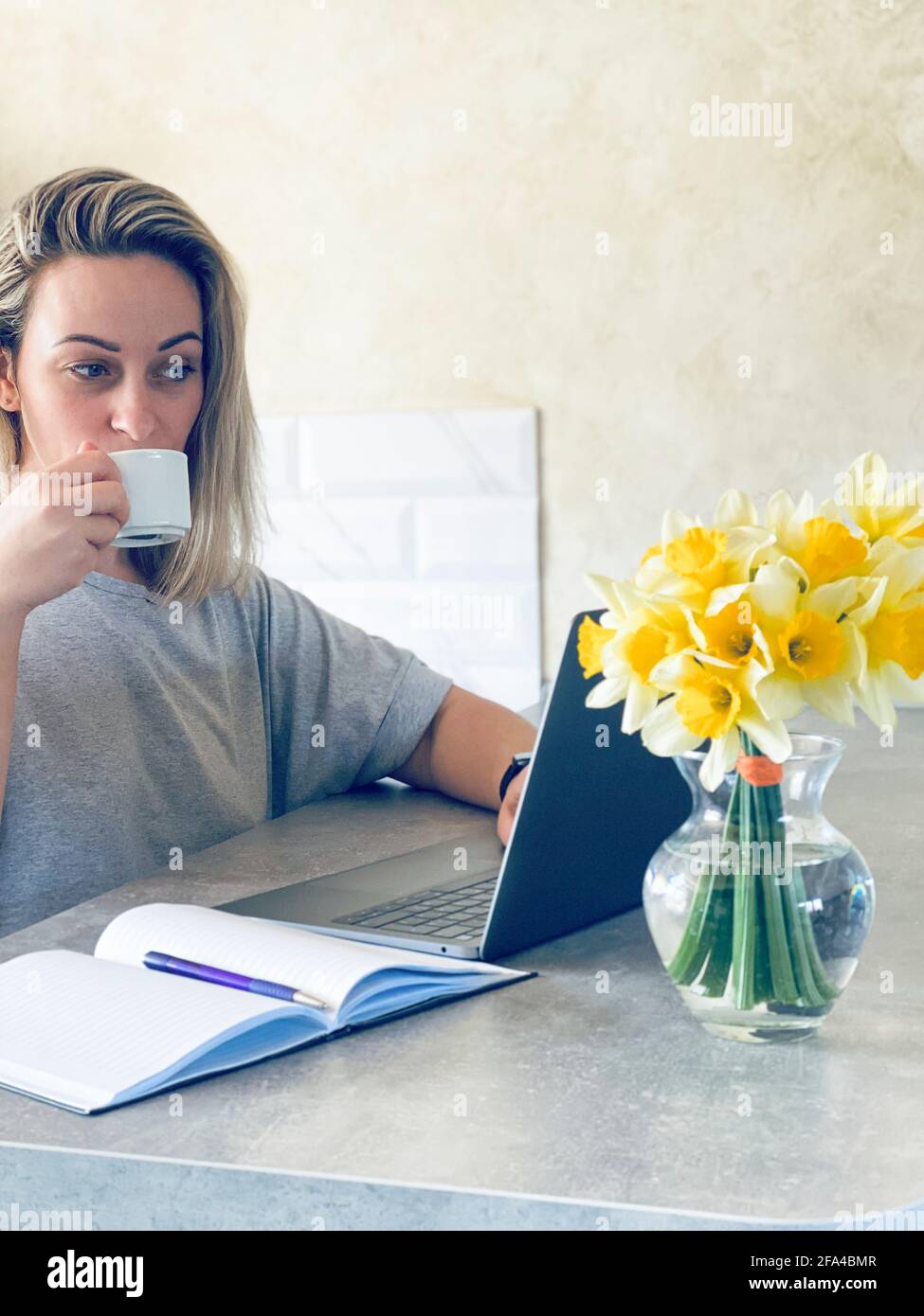 woman working at the computer and drinking coffee Stock Photo