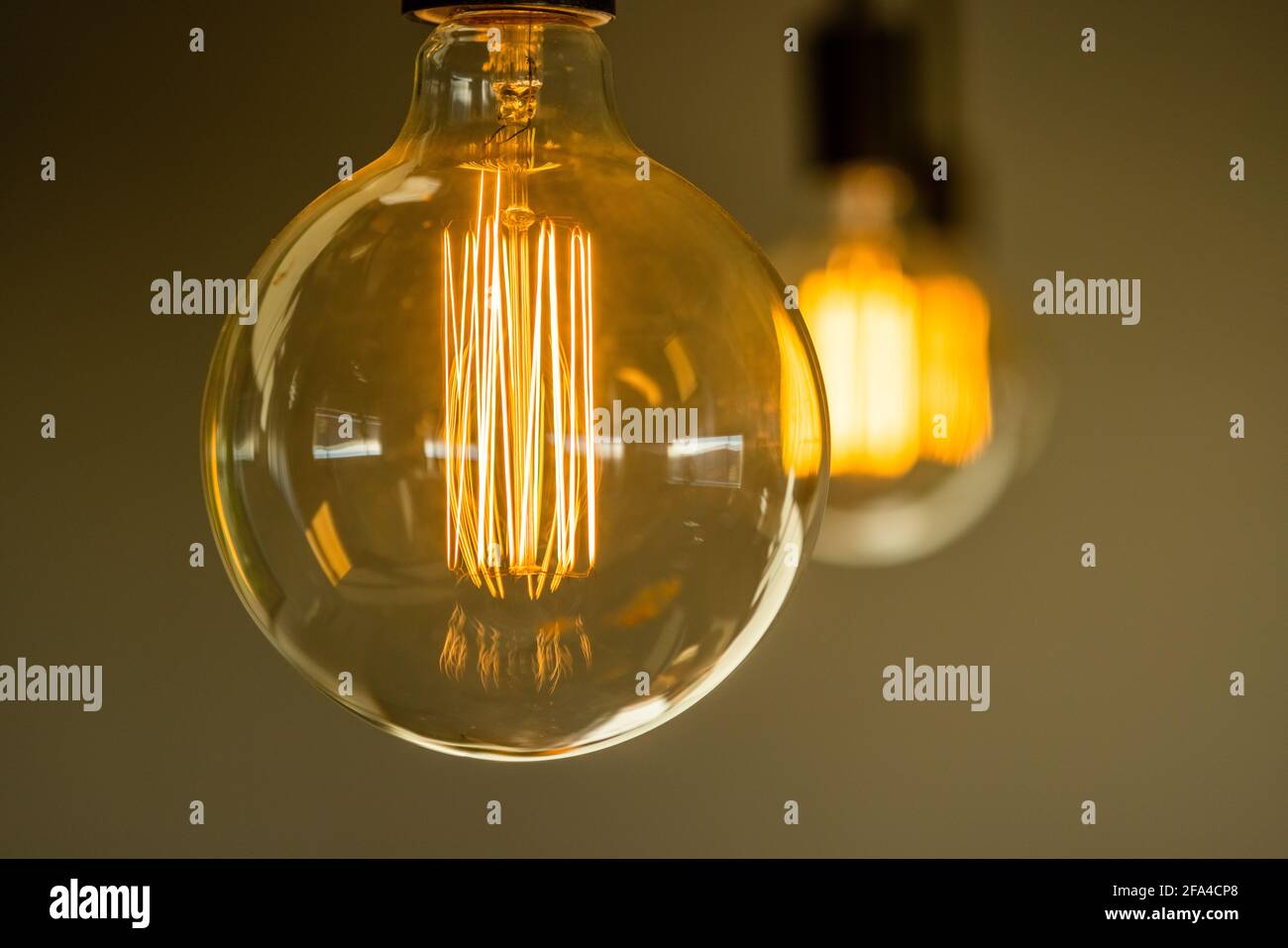 Closeup of Glowing Filaments of Light Bulbs Hanging From the Ceiling