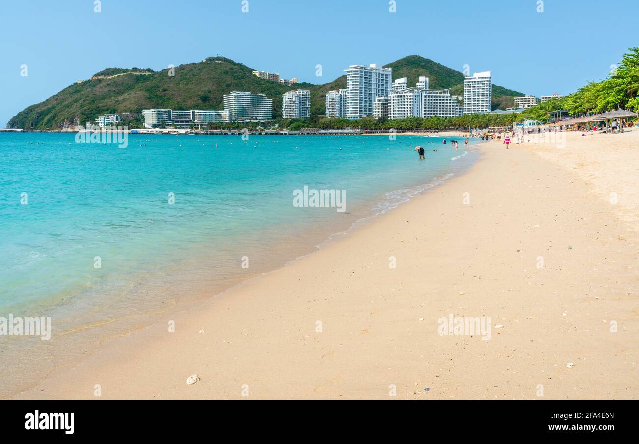 Scenic view of Dadonghai white sand beach with blue sky and Luhuitou peninsula view in Sanya in Stock Photo
