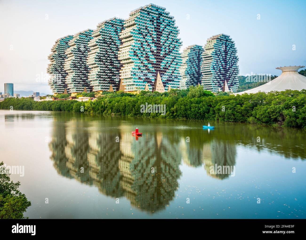 Sanya China , 25 March 2021 : Beautiful view of Beauty Crown Grand Tree hotel buildings aka Lego trees hotel with water reflection on Linchun river in Stock Photo
