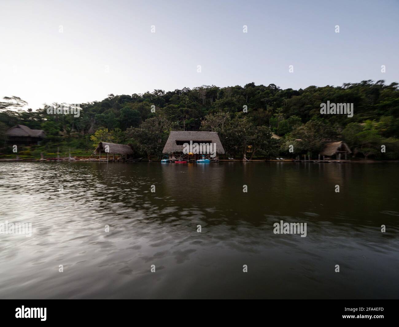 Aerial panorama view of Amazon tropical rainforest exotic lush jungle eco lodge hotel wooden cabin stilt hut at river lake in South America Stock Photo