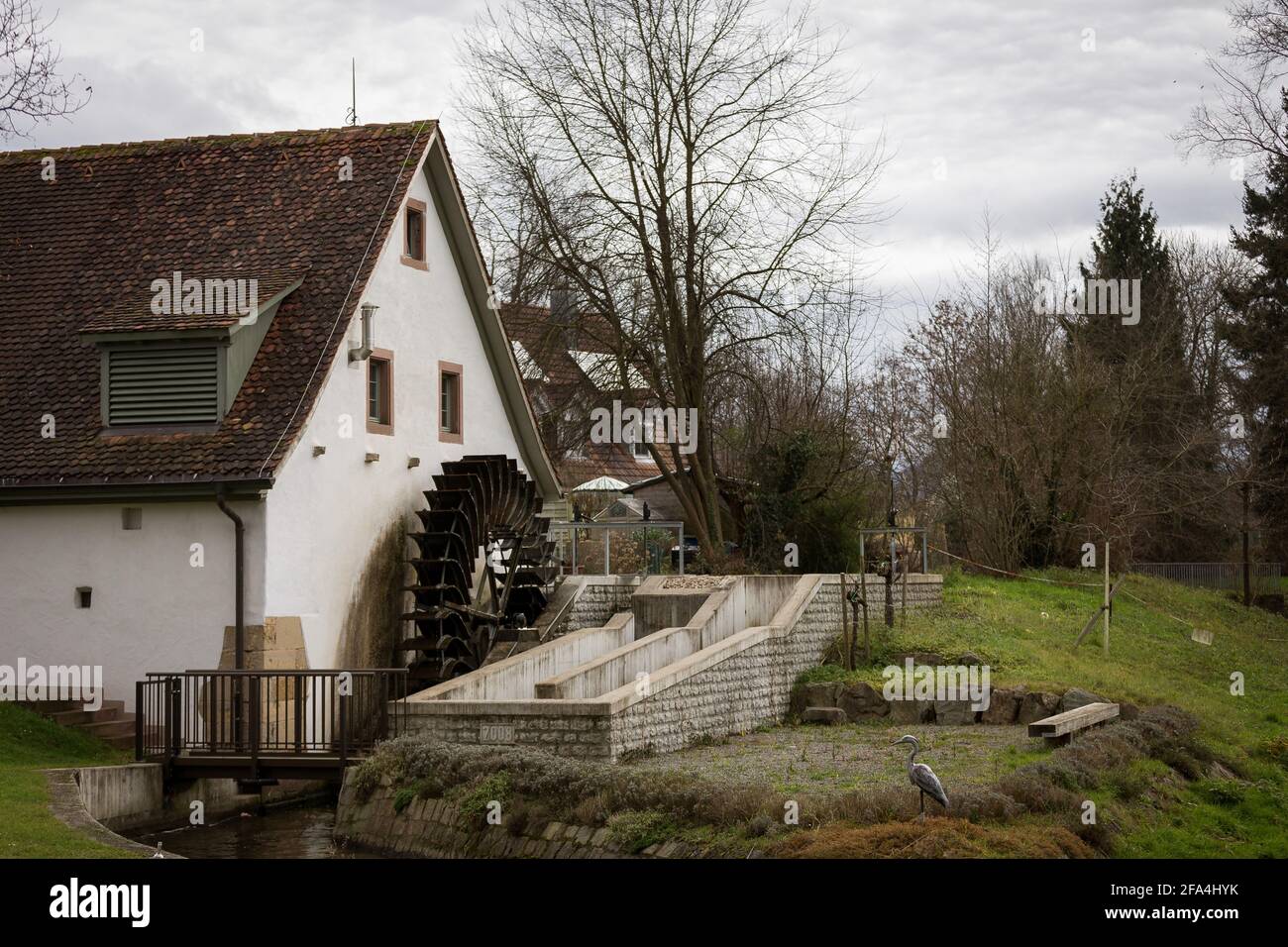 Umkirch, Germany - December 24, 2014: A morning view of a house with a watermill in the city of Umkirch, Germany. Stock Photo