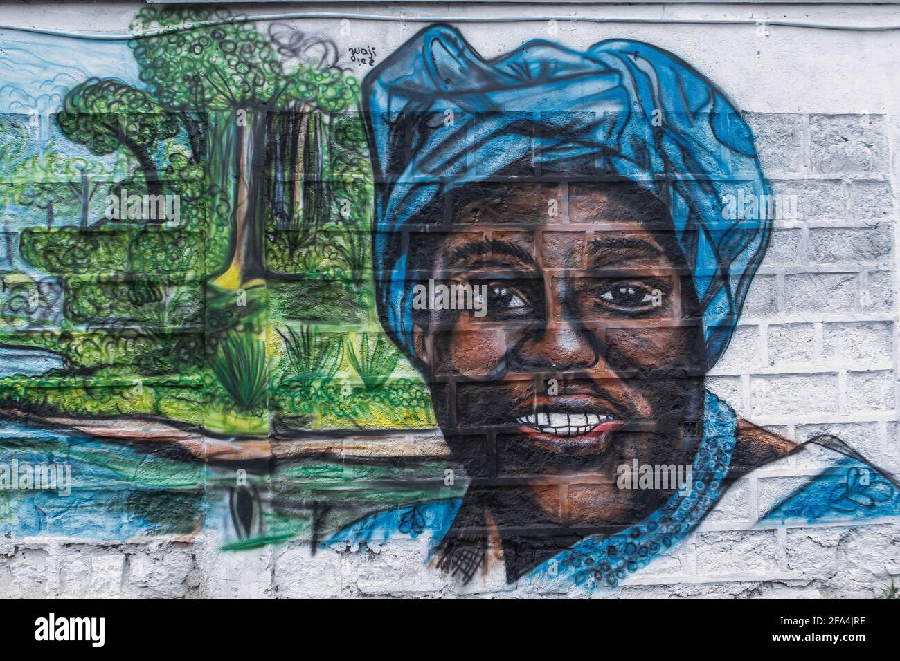 A mural of the Late Professor Wangari Maathai Nobel Peace Prize Winner painted by Pius Kiio Kitheka also known as Waji Dice a Kenyan youth 20year old passionate about graffiti seen in Kiserian.As the world celebrates Earth Day to acknowledge climate change and spread awareness about the same all around the world. This day is an opportunity that brings millions to connect and discuss problems like pollution, deforestation and more. This year's theme for the Earth Day is “ Restore Our Earth”. Earth day events range from river cleanups, tree planting, trash picking, removal of invasive plants. Th Stock Photo