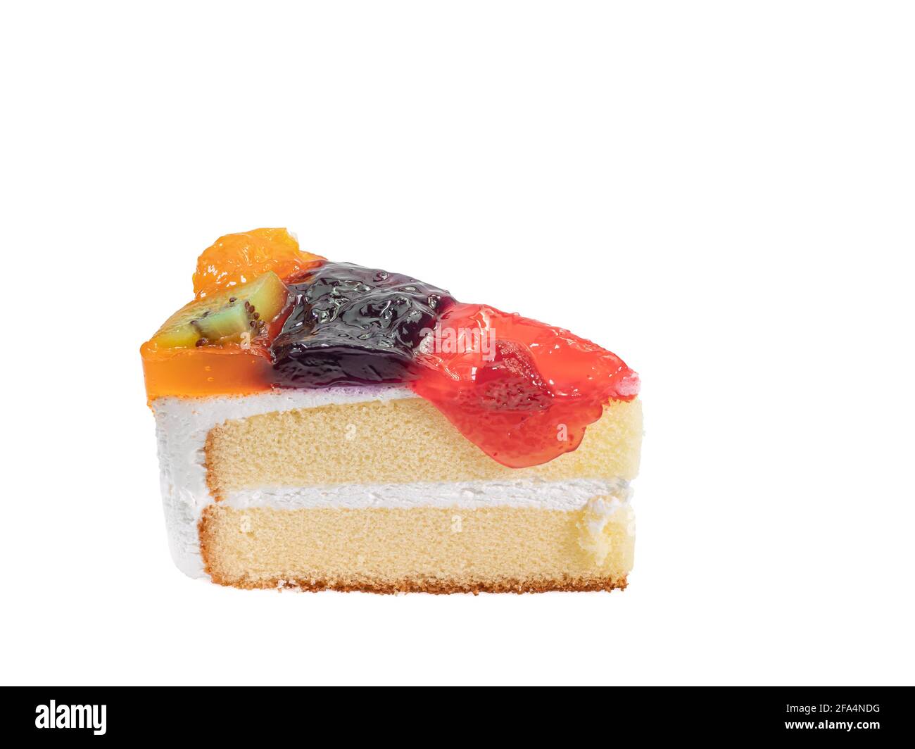 Mixed fruit cake, a close up of homemade fruitcake bakery with kiwi, orange, blueberry and strawberry topping isolated on white background. Stock Photo