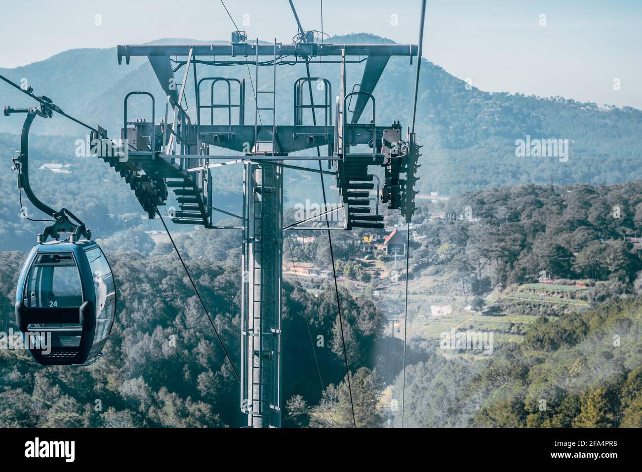 Circulating cable car between Dalat bus station and Robin Hill Truc Lam Vietnam. Close-up view of intermediate support tower. Picturesque landscape Stock Photo