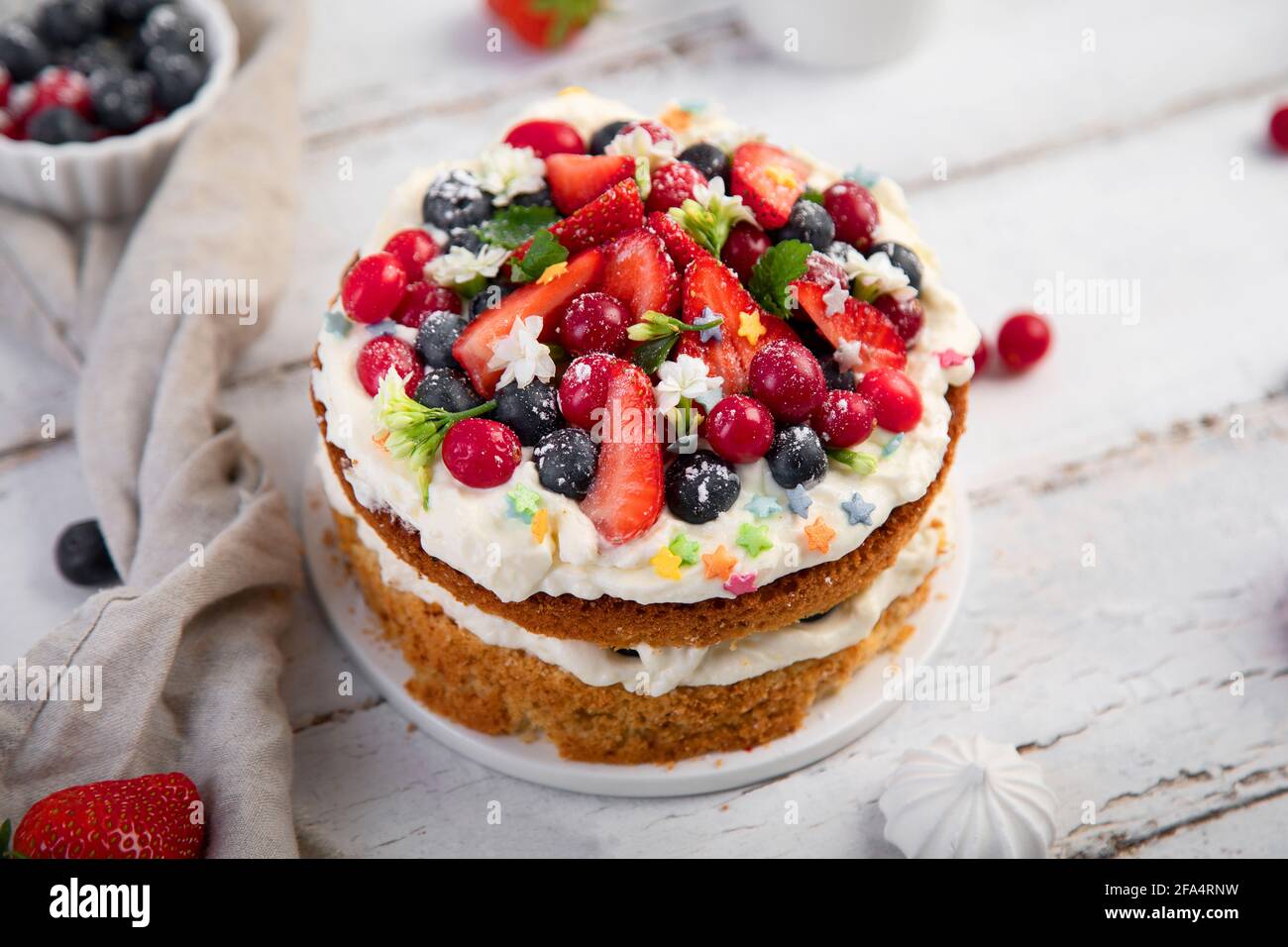 Delicious homemade cake with fresh berries and mascarpone cream on wooden background. Stock Photo