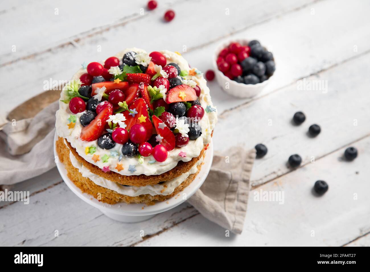 Delicious homemade cake with fresh berries and mascarpone cream on wooden background. Top view, copy space Stock Photo