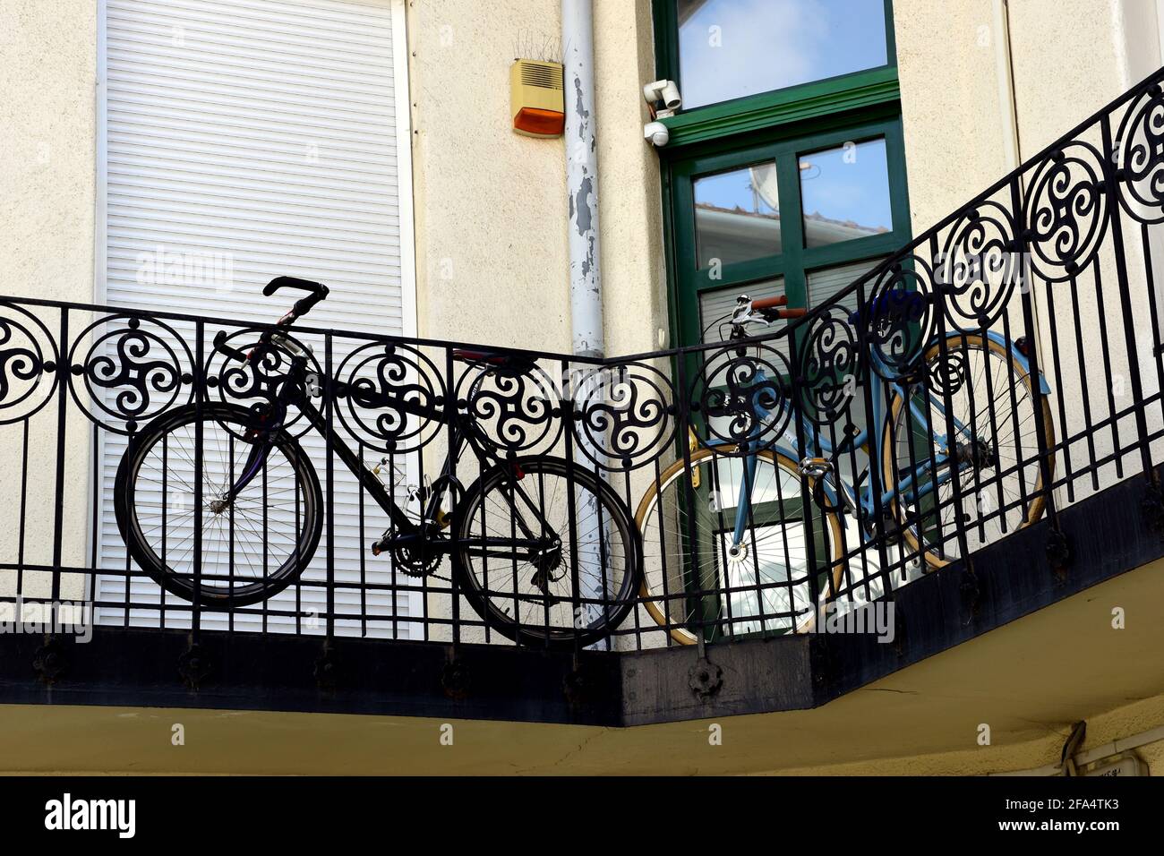 Bicycles parked and stored along old European apartment building ...
