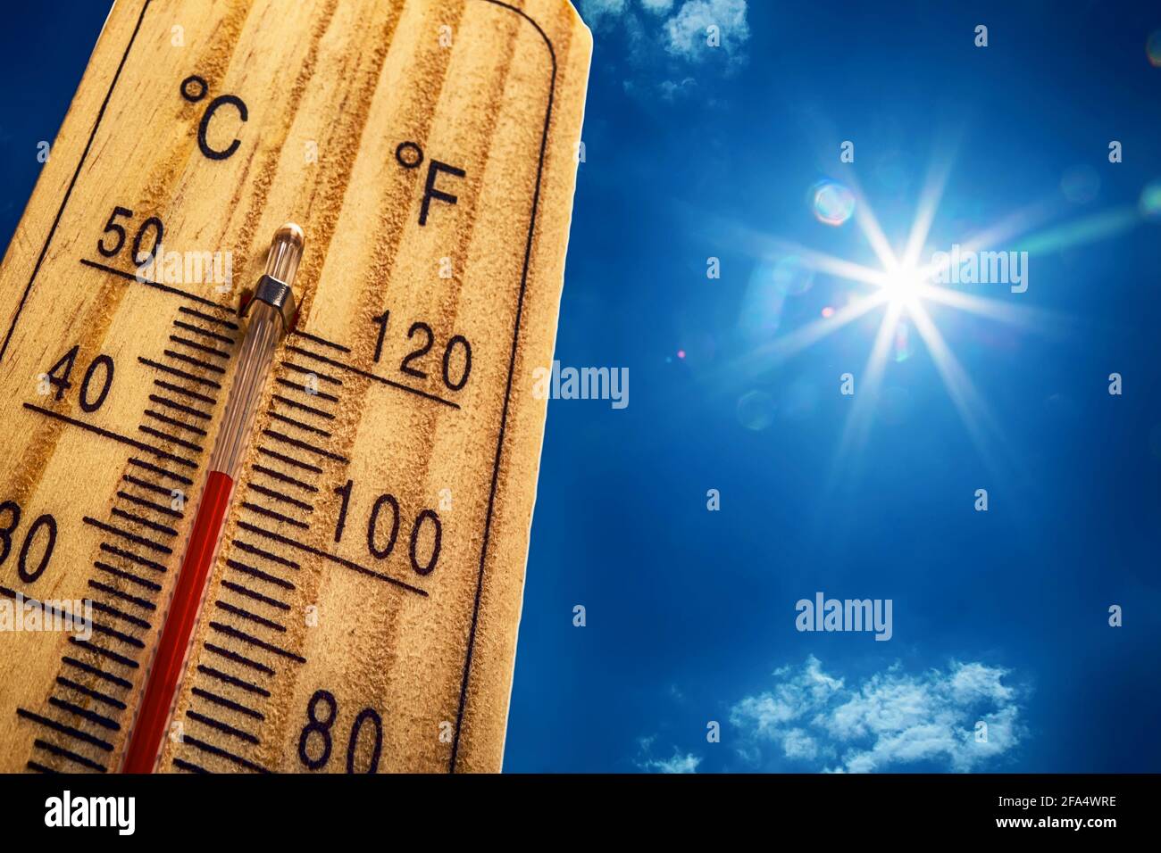 Thermometer Sun Sky 40 Degres. Hot summer day. High Summer temperatures in degrees Celsius and Farenheit. Stock Photo