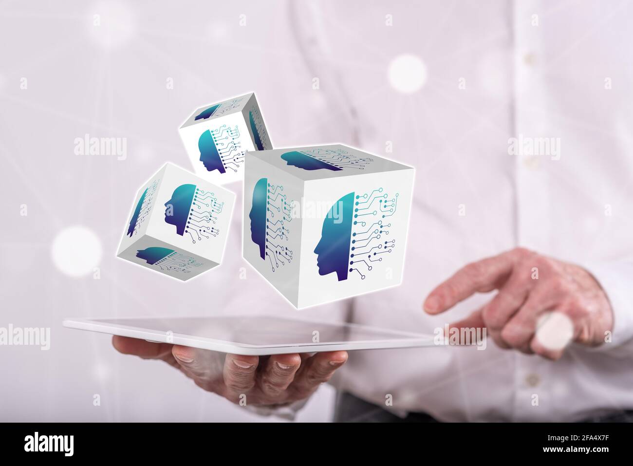 Machine learning concept above a tablet held by a man in background Stock Photo