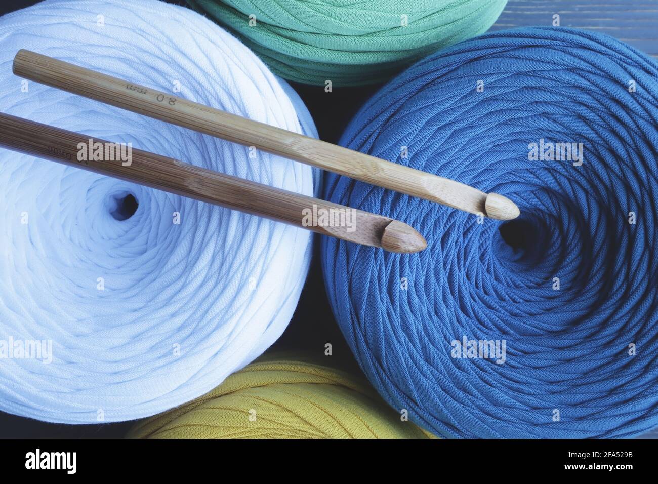 Colorful skeins of yarn and crochet hooks . Hobbies. Stock Photo
