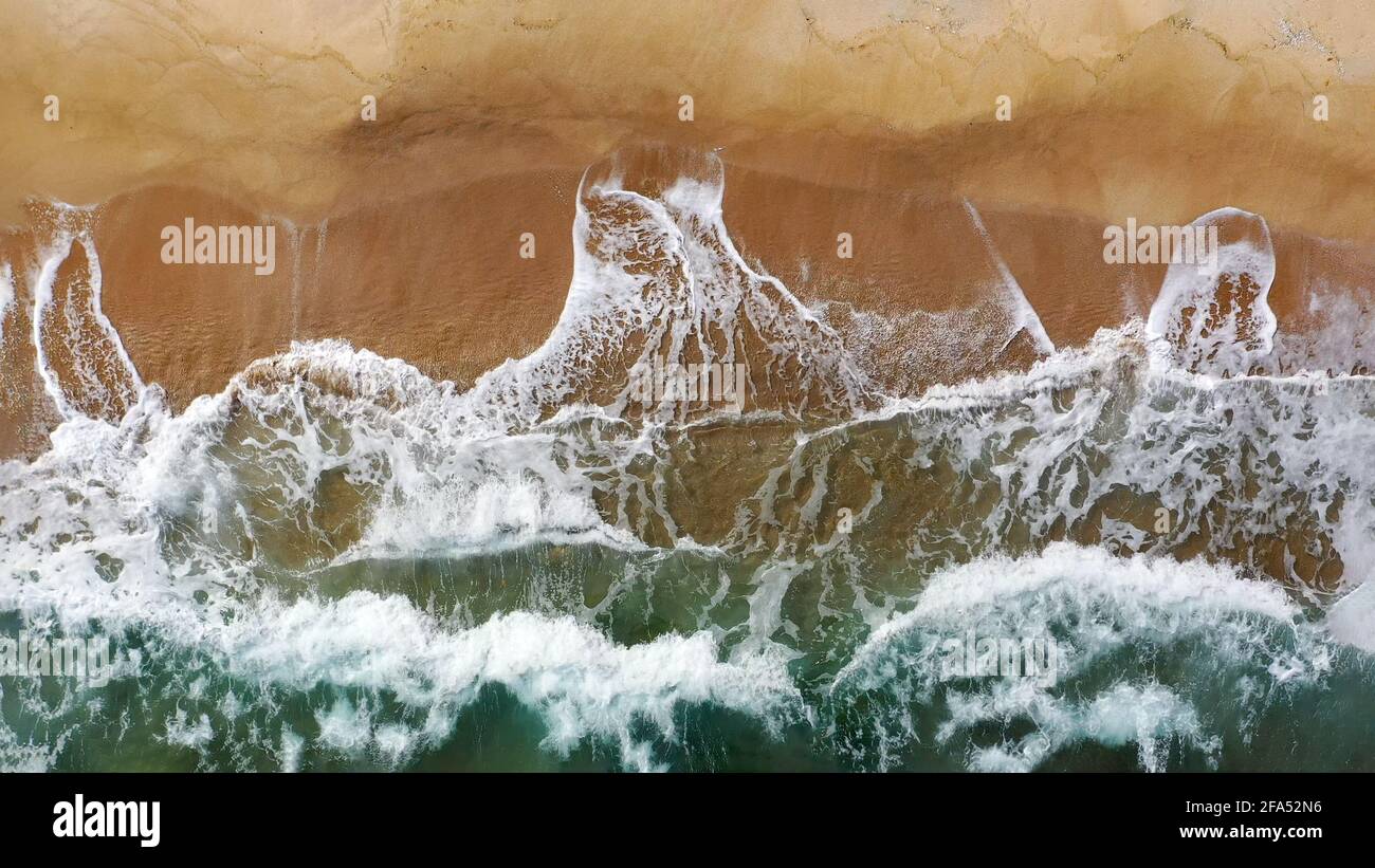 Aerial image of seashore with clear water and many crashing waves as background Stock Photo