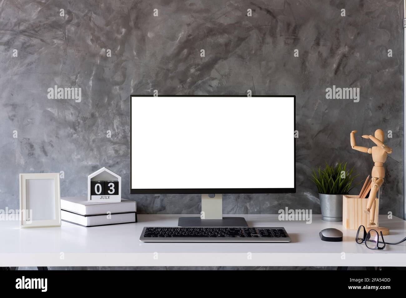 Mock up : Stylish or designer workspace with desktop computer, creative supplies, houseplant and vintage books on white work table at home or studio Stock Photo