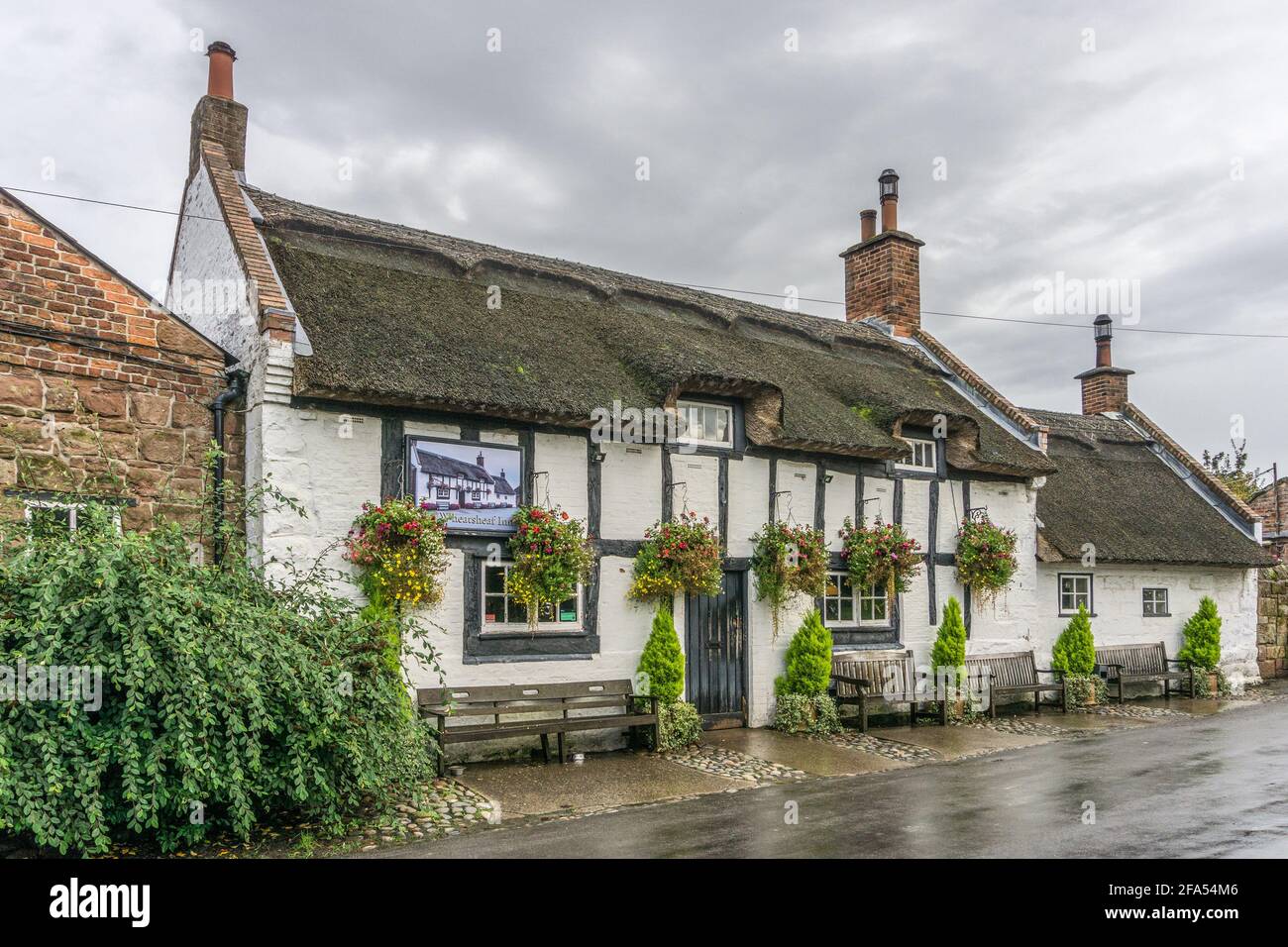 The Wheatsheaf Inn and Cowshed Restaurant, Raby, Wirral, UK; a thatched pub dating from 1611 and the oldest pub on the Wirral. Stock Photo