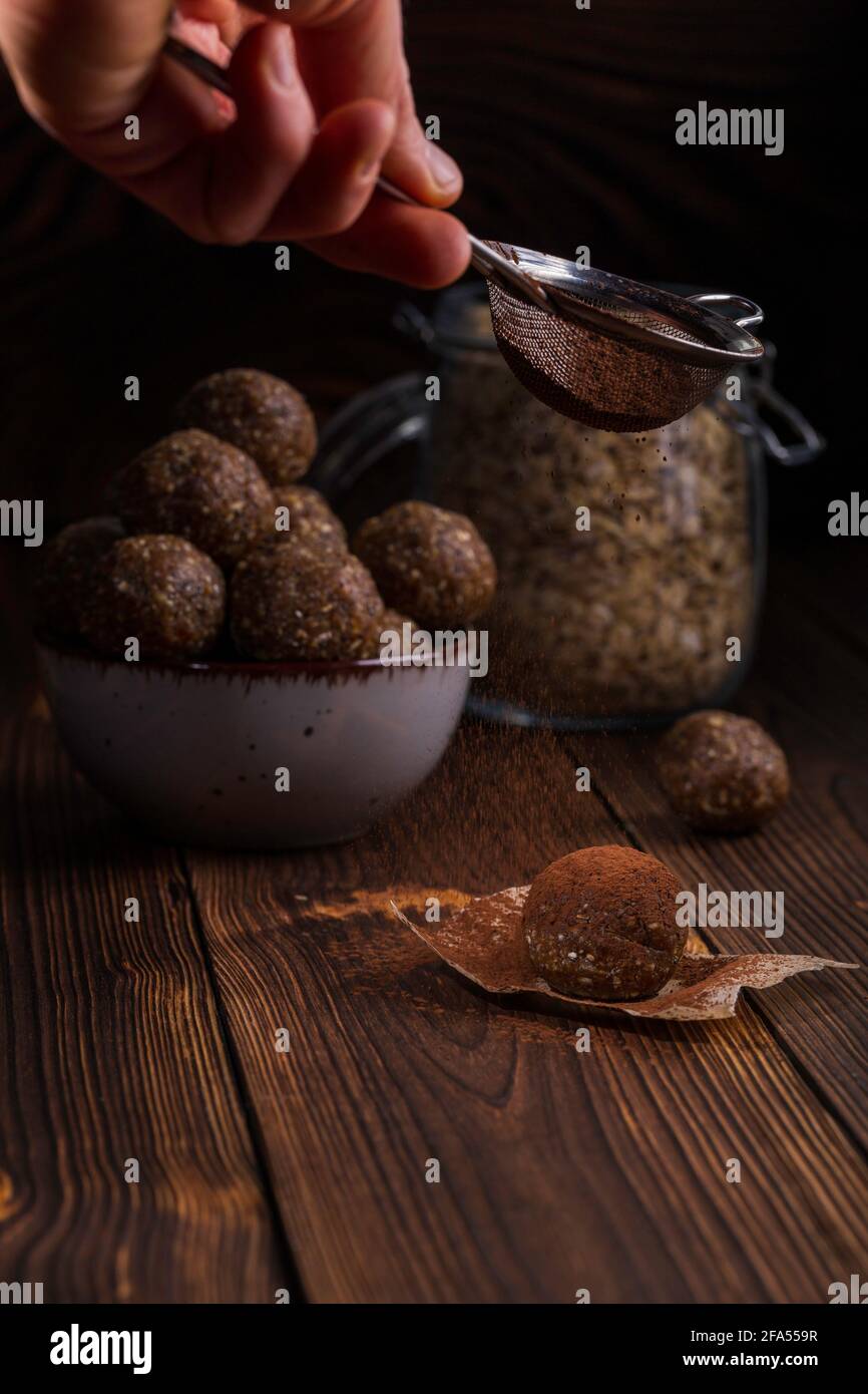Healthy homemade power balls dessert made with oatmeal, dates, peanut butter, and other bacalias. Stock Photo