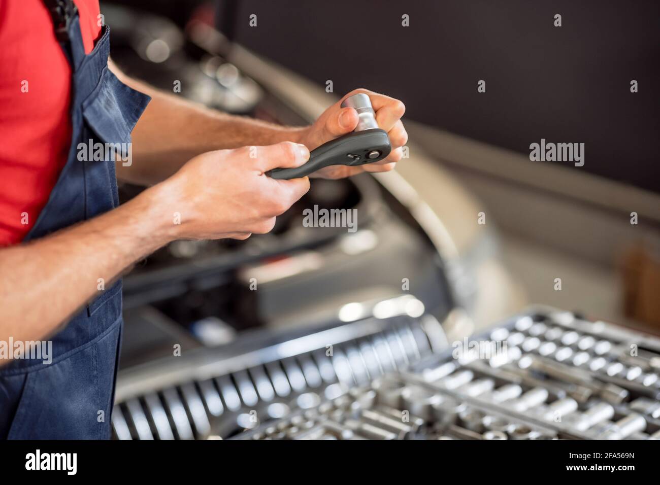 Happy Car Mechanic Busy Using Mobile Phone at Garage in Front of Repair Car  with Opened Hood - Concept of Using Stock Image - Image of engineer,  professional: 243464133