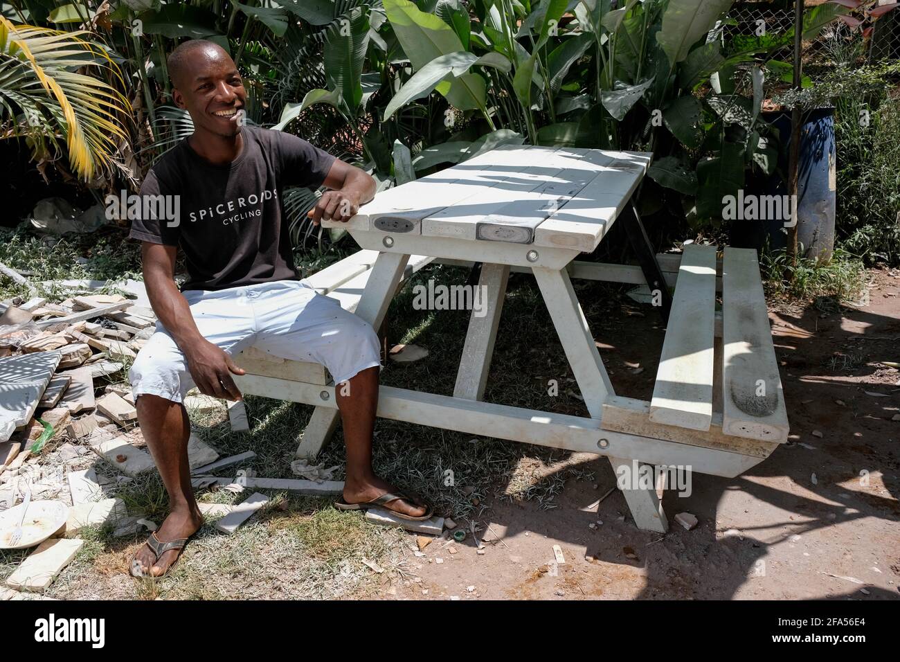 Kampala, Uganda. 24th Mar, 2021. Gerald Ndashimye sits on an outdoor