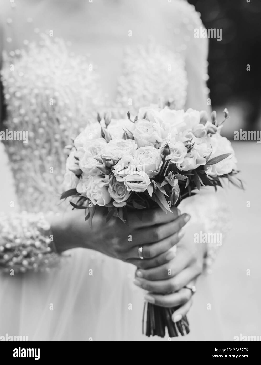 bride holds a bouquet of flowers. black and white image Stock Photo - Alamy