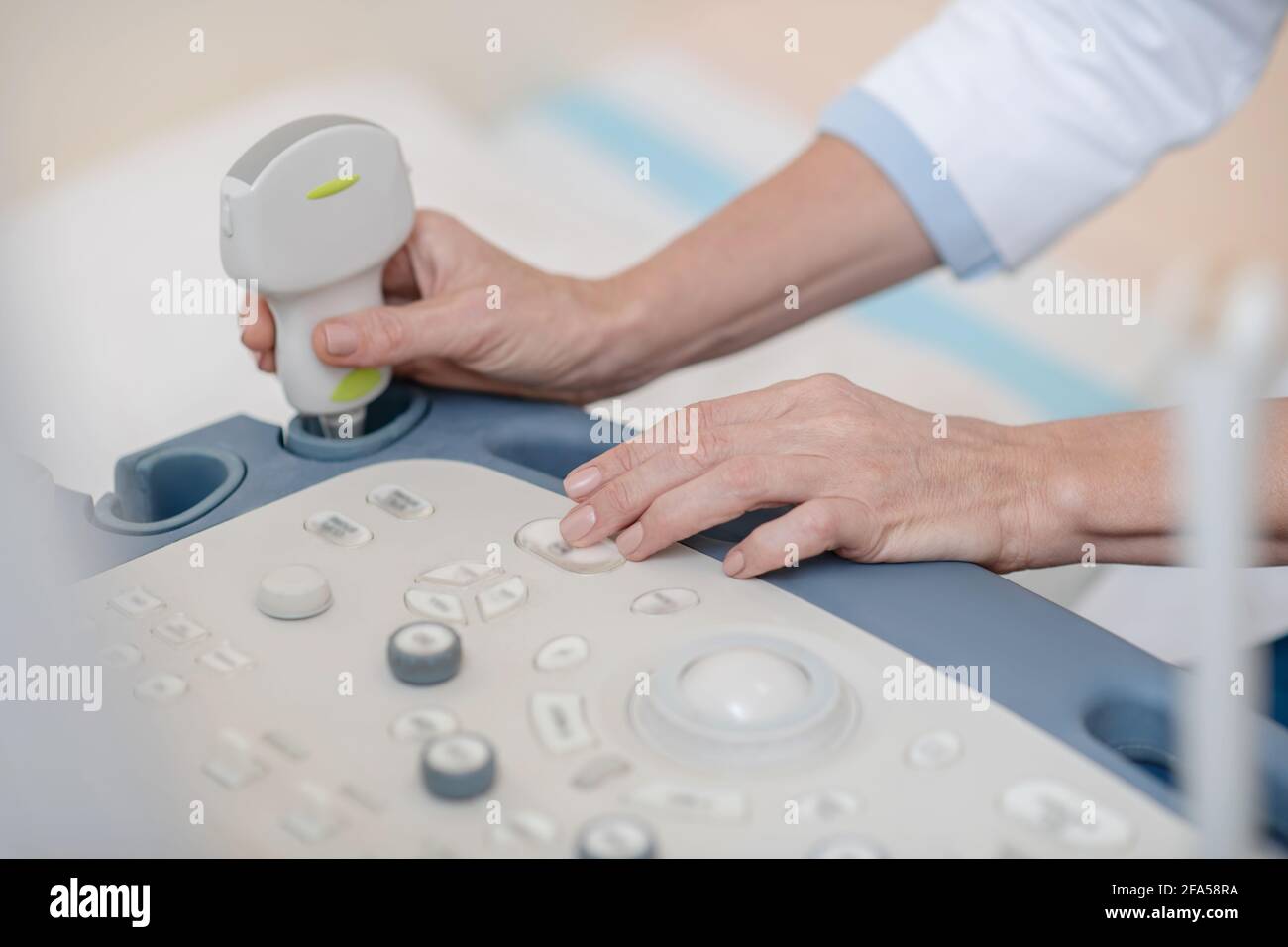 Hands of doctor near control panel and ultrasound sensor Stock Photo
