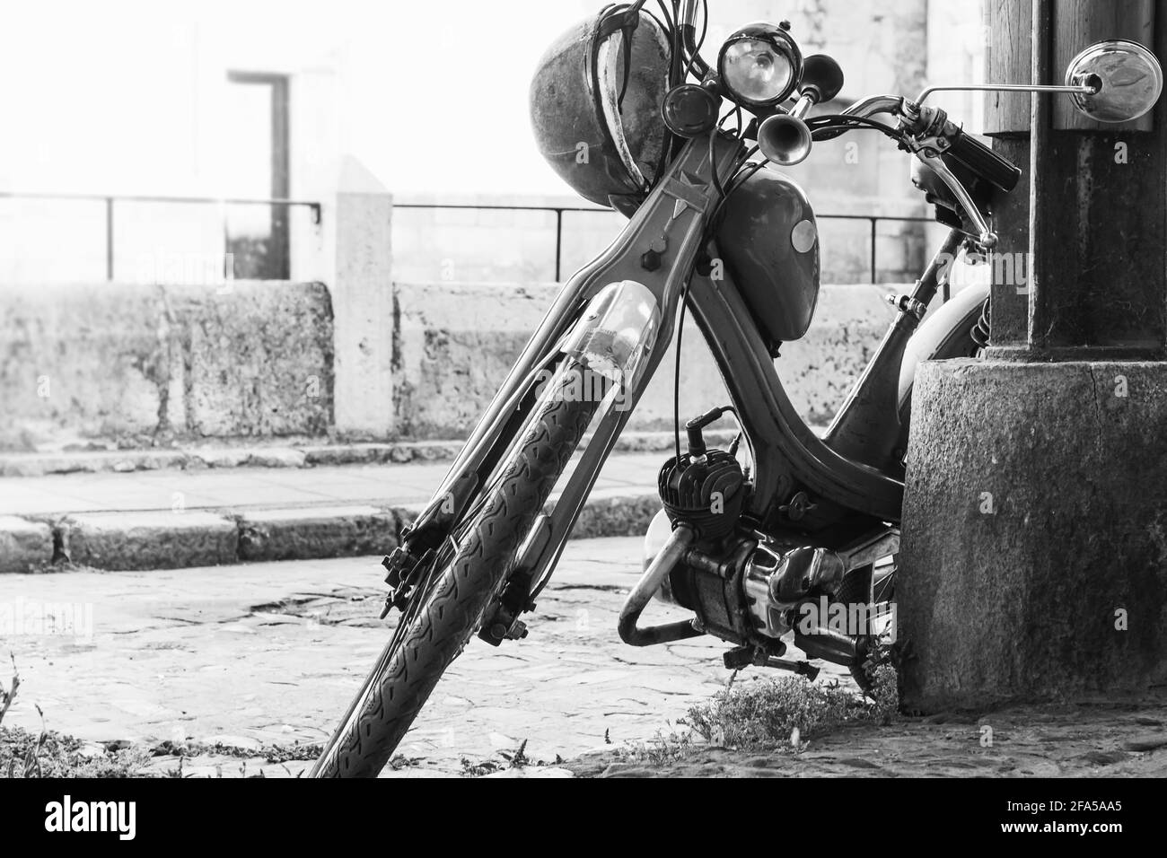 Motorcycle and old town on a street in Castilla y Leon.The photograph is in black and white and is taken in horizontal format. Stock Photo