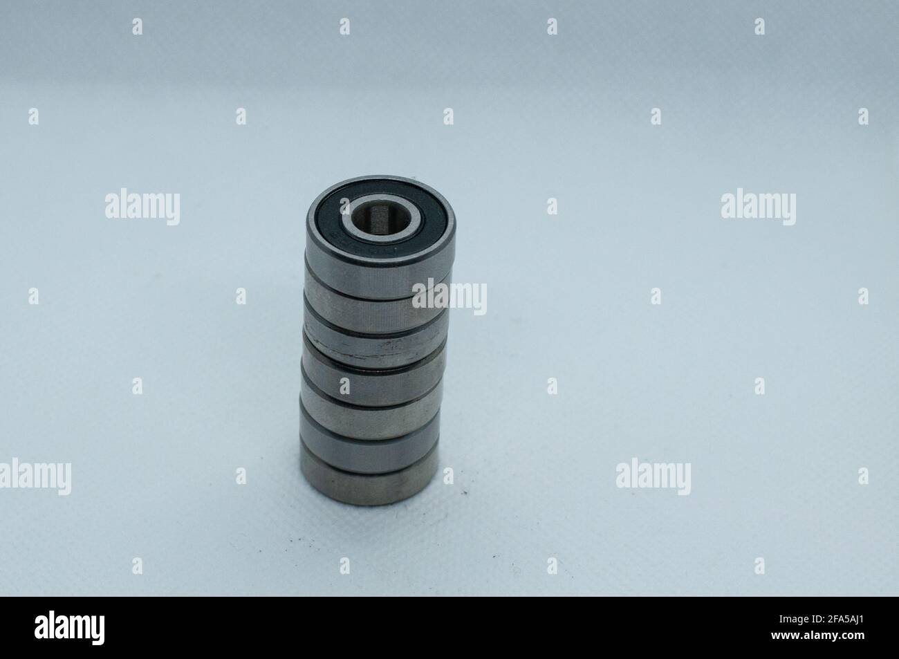 Closeup of ball bearings stacked on top of each other on a plain white background Stock Photo