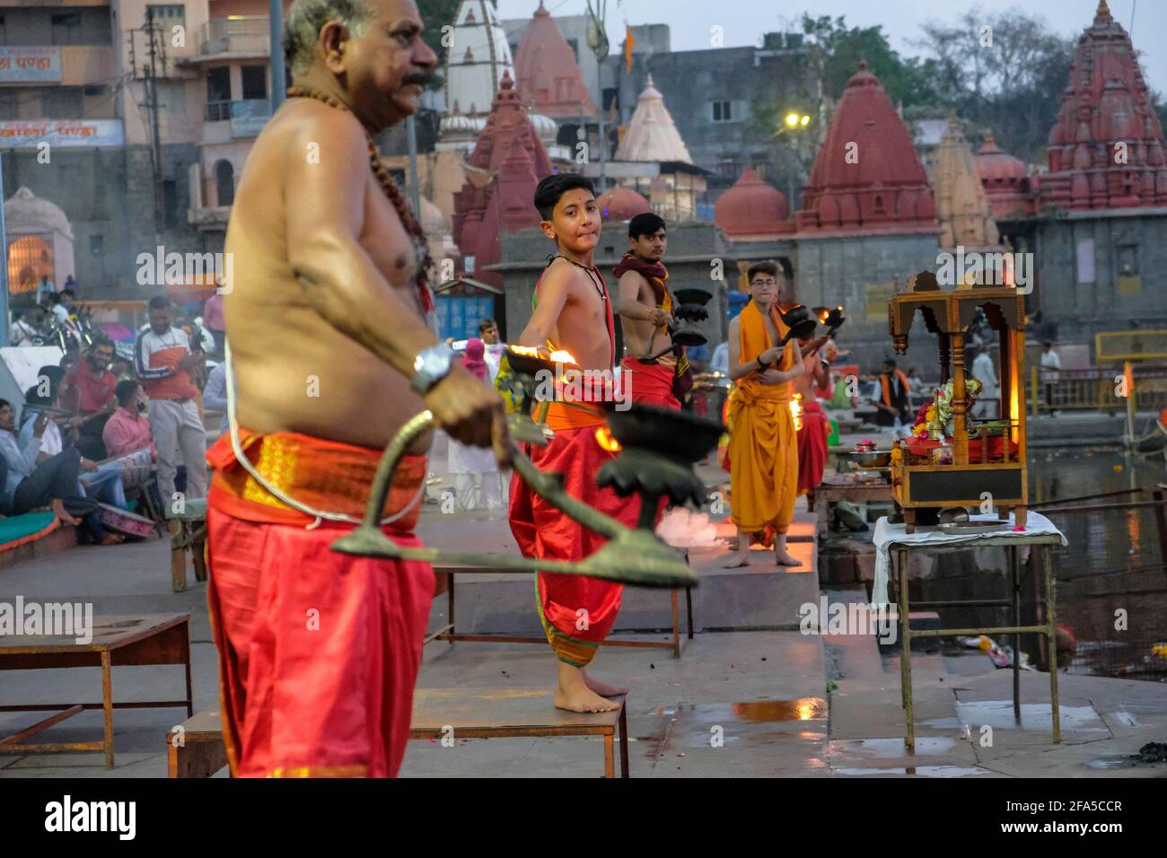 Ujjain, India - March 2021: Priests performing Evening Aarti on the Ujjain ghats on March 24, 2021 in Madhya Pradesh, India. Stock Photo