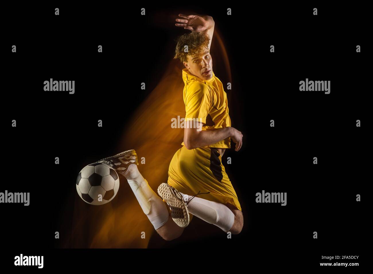 pro soccer player kicking ball