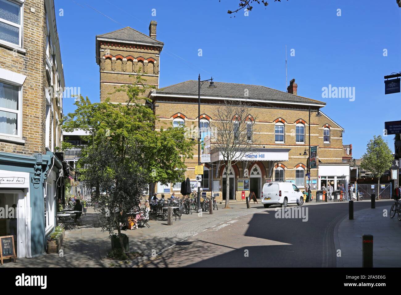 Cafes and shops on Railton Road outside Herne Hill railway station in south London, UK. Stock Photo