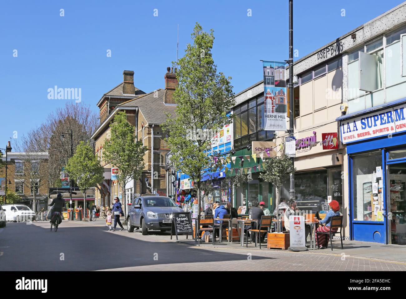 Cafes and shops on Railton Road outside Herne Hill railway station in south London, UK. Stock Photo