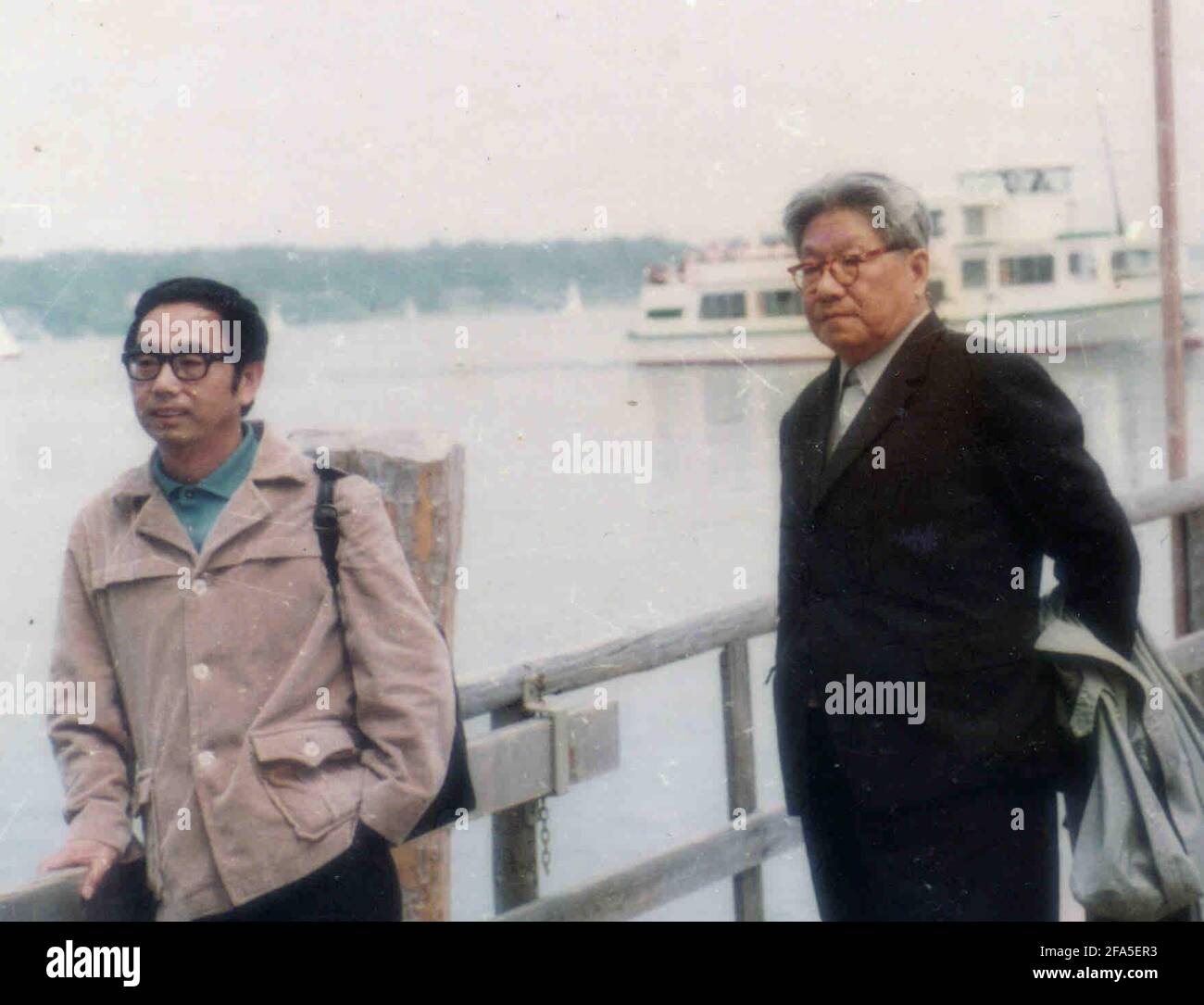 (210423) -- CHENGDU, April 23, 2021 (Xinhua) -- File photo taken in autumn 1982 shows Yang Wuneng (L) posing with his academic instructor Feng Zhi, another renowned figure in the German studies, by the Rhine River in Germany. In a career that spans over 60 years, Yang Wuneng has translated 31 German classics into the Chinese language, including 'Faust', 'Selected Poems of Heinrich Heine' and 'Immensee.' Many of his translations are still bestselling books in some bookstores. His translation of 'Grimms' Fairy Tales,' for instance, has been popular among Chinese readers for many generations. Tod Stock Photo