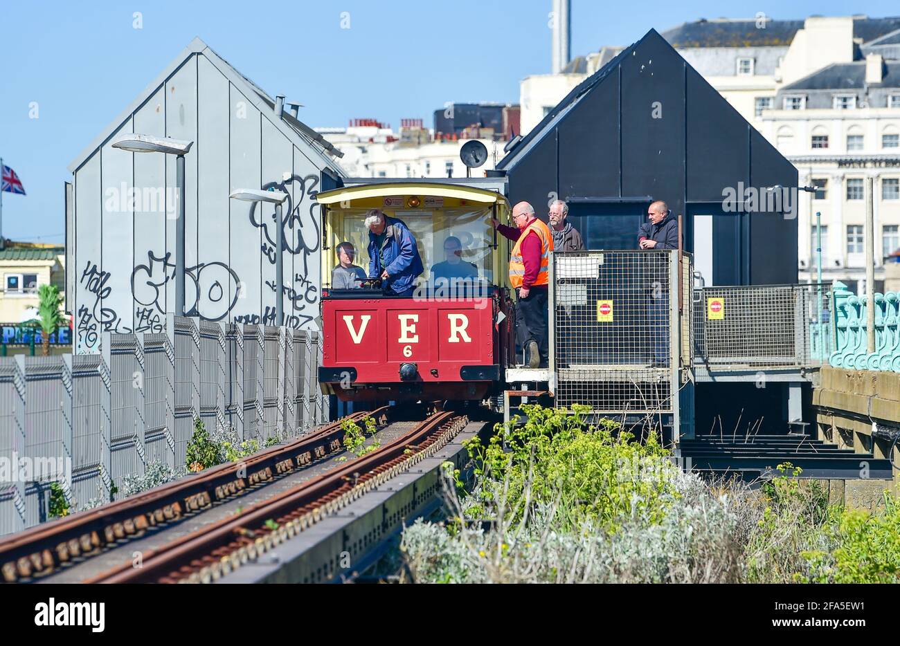 Brighton, UK. 23rd Apr, 2021. Volunteers including BBC newsreader Nicholas Owen (front centre) on the Volk's Electric Railway on Brighton seafront today as they prepare to reopen in late May for the summer season . The Volk's Railway was the first public electric railway in the world and was opened in 1883 by Magnus Volk. : Credit: Simon Dack/Alamy Live News Stock Photo