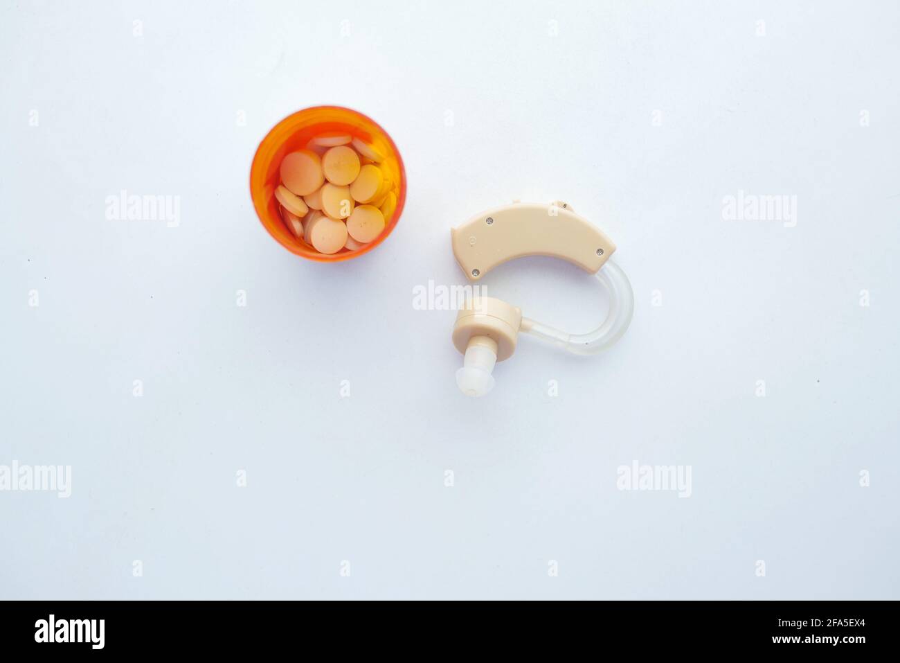 Hearing aid equipment and medical pill container on white background