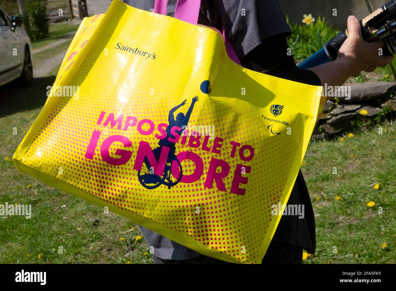 Sainsbury's store 'Impossible to ignore' Paralympics GB logo on yellow plastic shopping bag customer in Wales UK  KATHY DEWITT Stock Photo