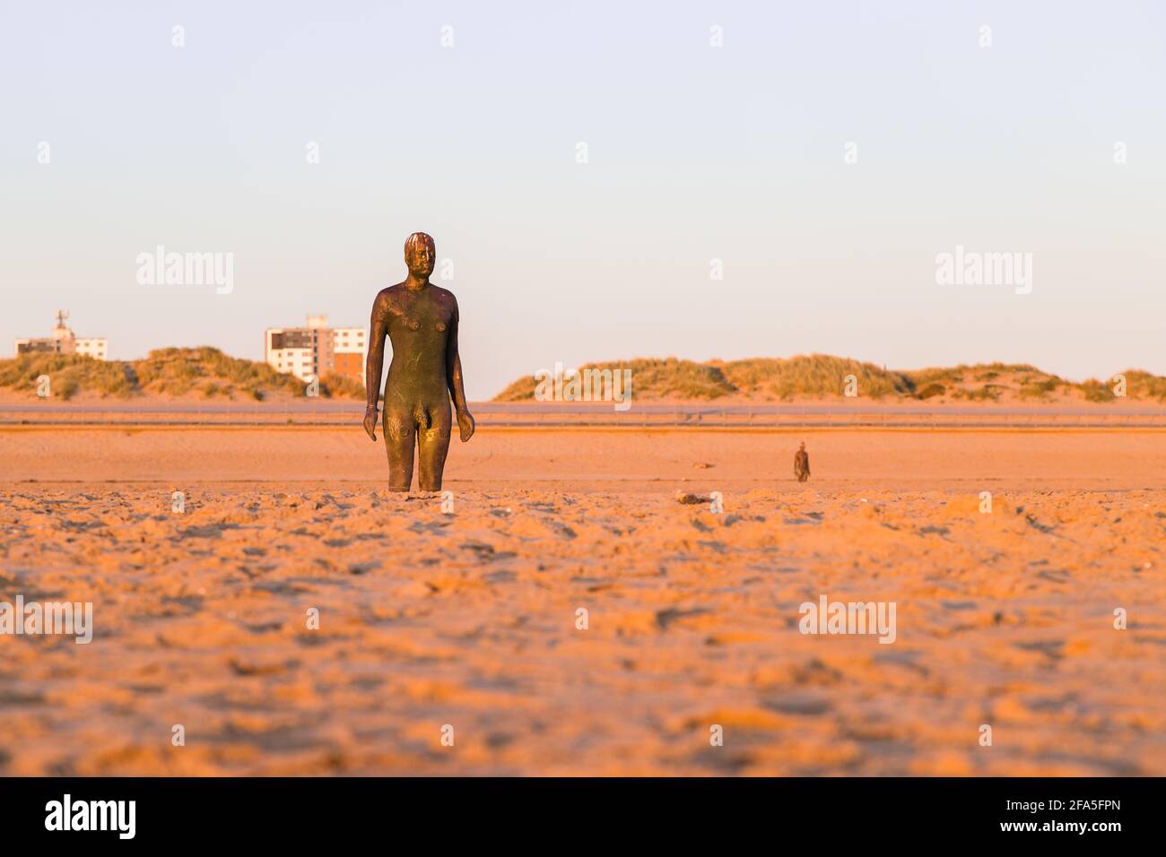 Two of the one hundred Iron Men statues on the beach at Crosby near