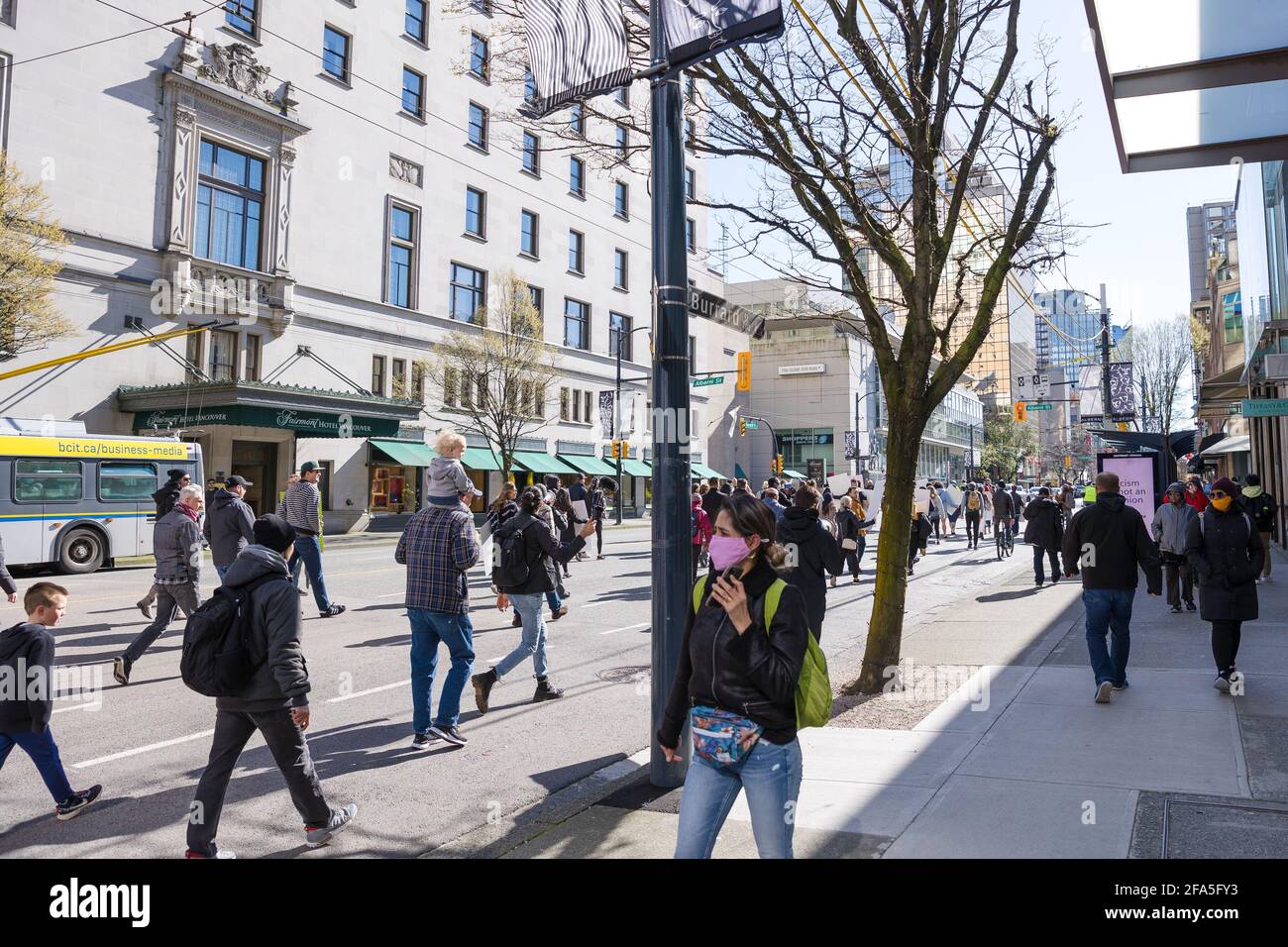 DOWNTOWN VANCOUVER, BC, CANADA - APR 02, 2021: Anti lockdown protesters march in protest of government imposed restaurant closures in order to slow Stock Photo