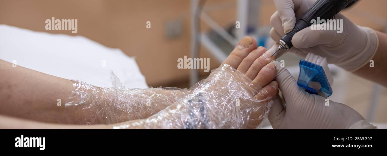 Female foot in process of pedicure procedure treatment stock photo Stock Photo
