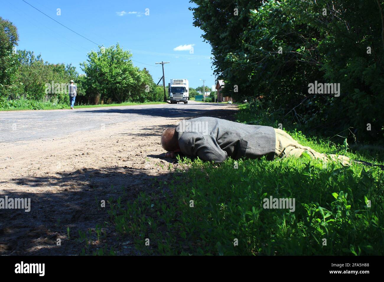 Novgorod, Russia, Aleksandr Kirillov - 06202012: 'A very drunk man sleeps on the ground' Stock Photo