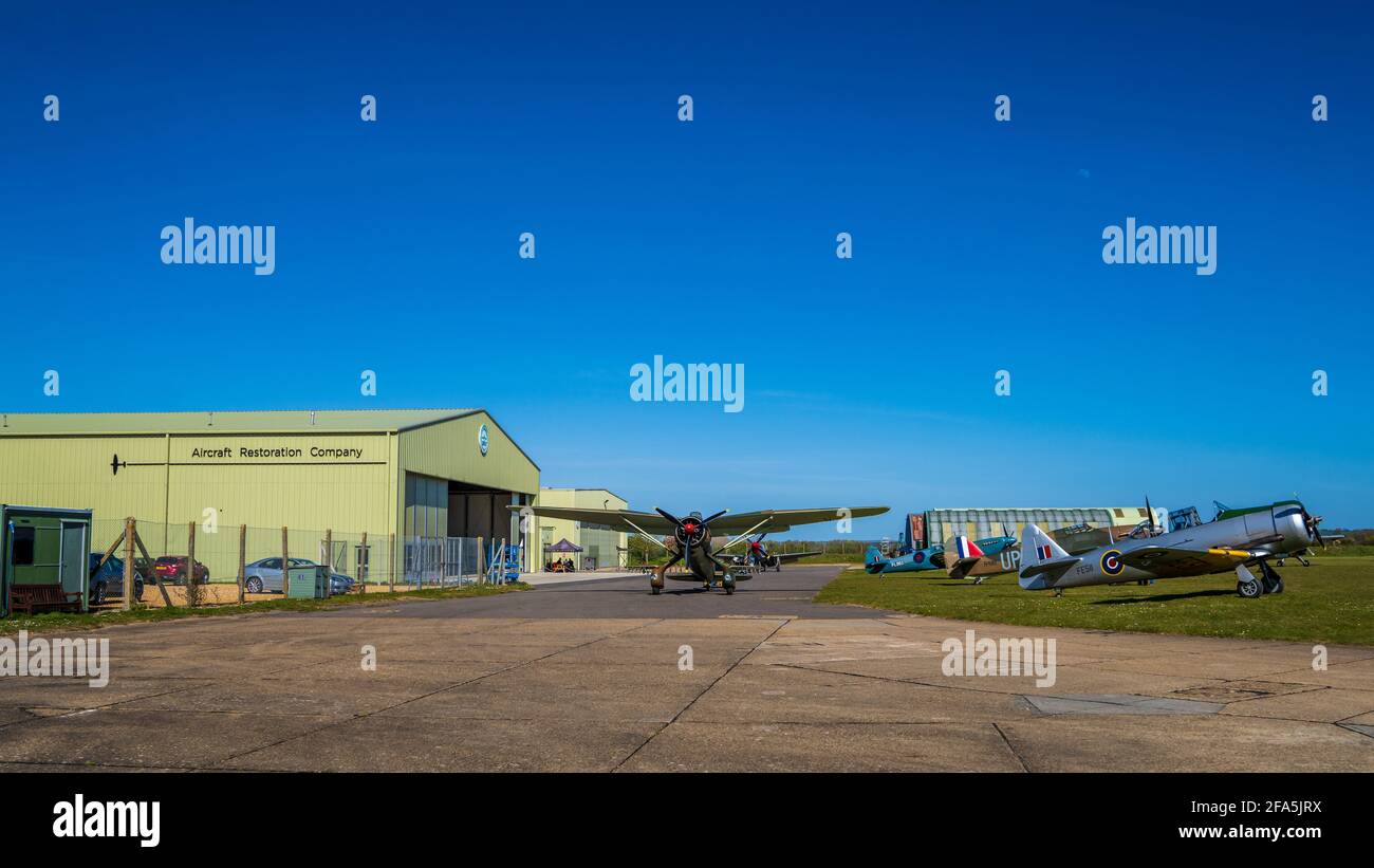 Historic aircraft outside the hangers of the Aircraft Restoration Company based at the Imperial War Museum Duxford airfield in Cambridgeshire, UK Stock Photo