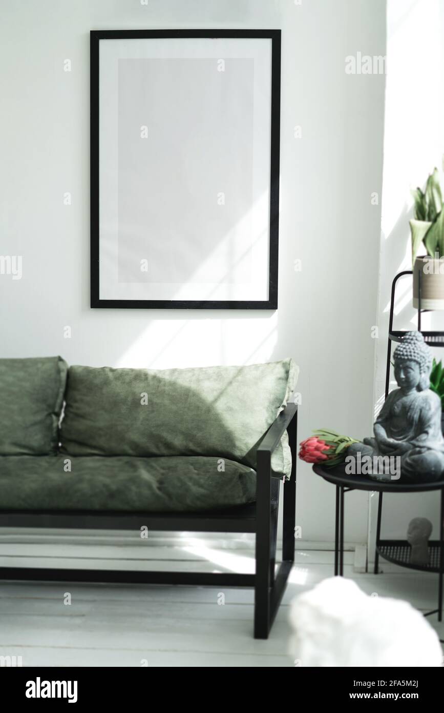 A mockup with a large black frame on the wall. Stock Photo