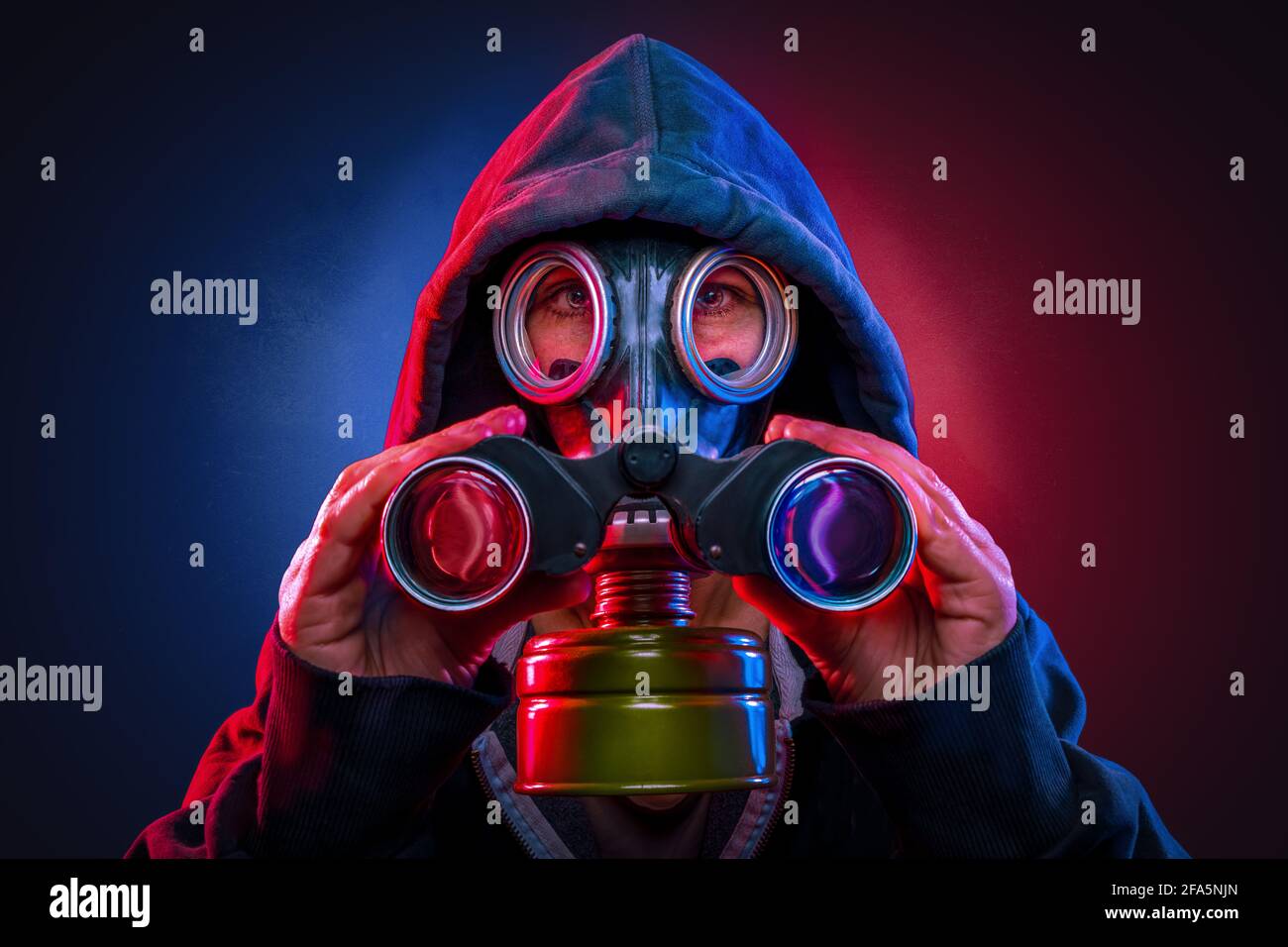 masked person using a spyglass Stock Photo