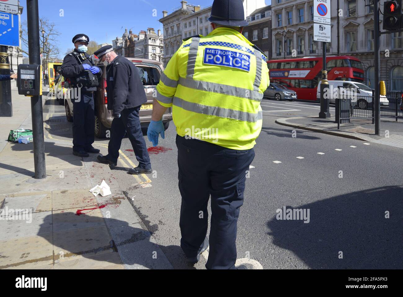 London, England, UK. Metropolitan Police officers attending a collision between a car and a cyclist at the corner of Whitehall and Parliament Square Stock Photo