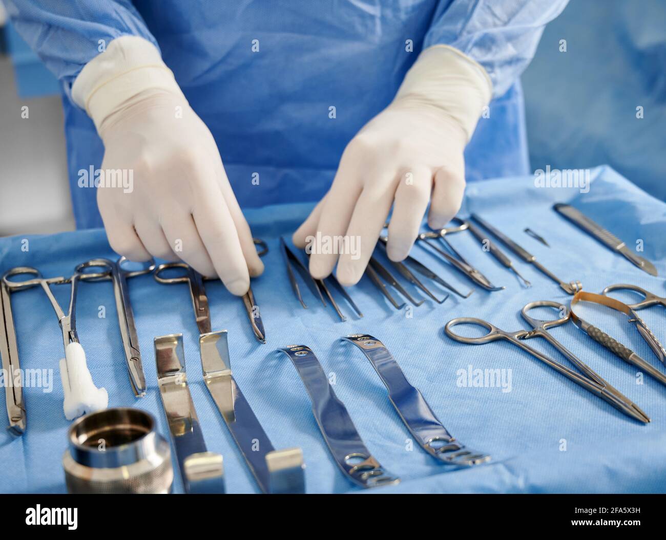 Close up of plastic surgeon in sterile gloves getting ready medical  instruments for operation. Doctor preparing scissors, forceps and scalpels  for surgery. Concept of plastic surgery preparation Stock Photo - Alamy
