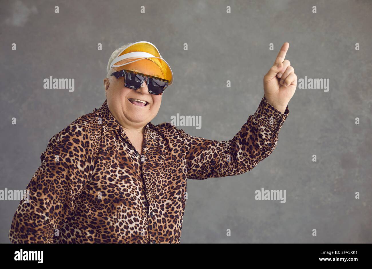 Headshot portrait of funny stylish handsome old man pointing up with finger Stock Photo