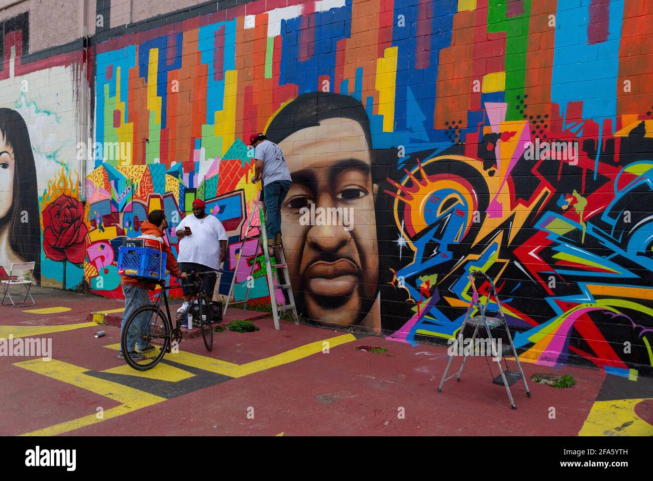 Houston, USA. 22nd Apr, 2021. The artist 'Empire' finishes repainting his George Floyd mural at Graffiti Park in Houston, TX on April 22, 2021, after it was defeced with a rascist slur overnight. (Photo by Jennifer Lake/SIPA USA) Credit: Sipa USA/Alamy Live News Stock Photo