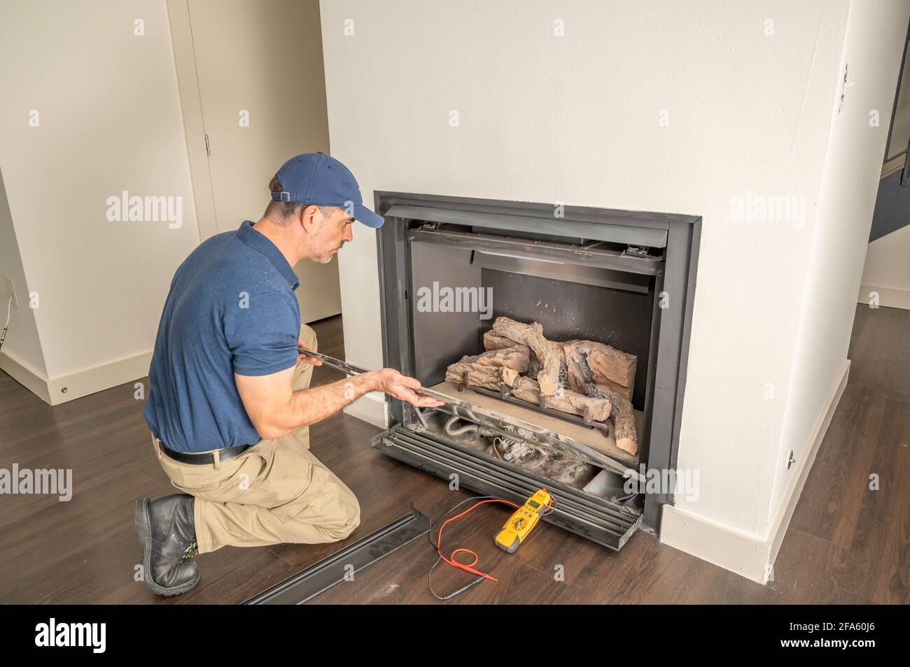 Service technician repairing a gas fireplace in a home Stock Photo Alamy