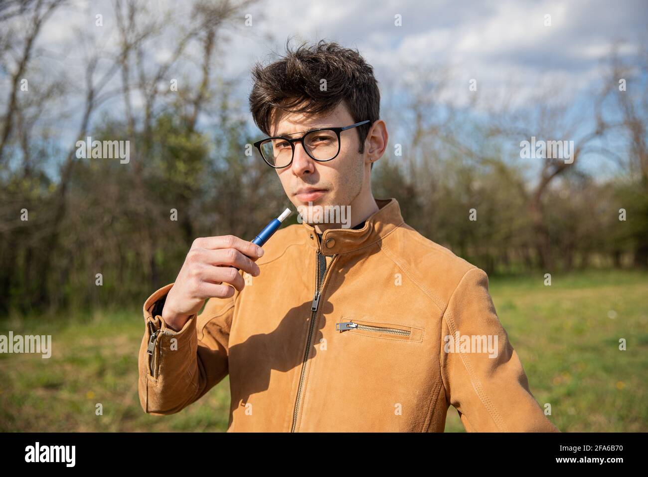 portrait of a young boy who smokes an electronic cigarette Stock Photo